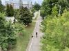 Photo of bike and biker riding on the multi-use path on Tech Parkway behind the Campus Recreation Center.