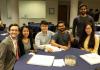 A group of students smiles at a table during the ISyE Student awards ceremony