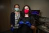 Two researchers standing in lab