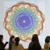 Students standing around a projection of DILAC's Heart Sense project.