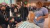 Exhibit team member talks to Smithsonian visitors with 3D map of Selma