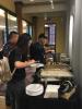 A picture of Ivan Allen College of Liberal Arts students eating food at a reception for international students. 