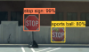 Image of a real stop sign with a bounding box and a fake stop sign with a bounding box and incorrect label saying 'sports ball'